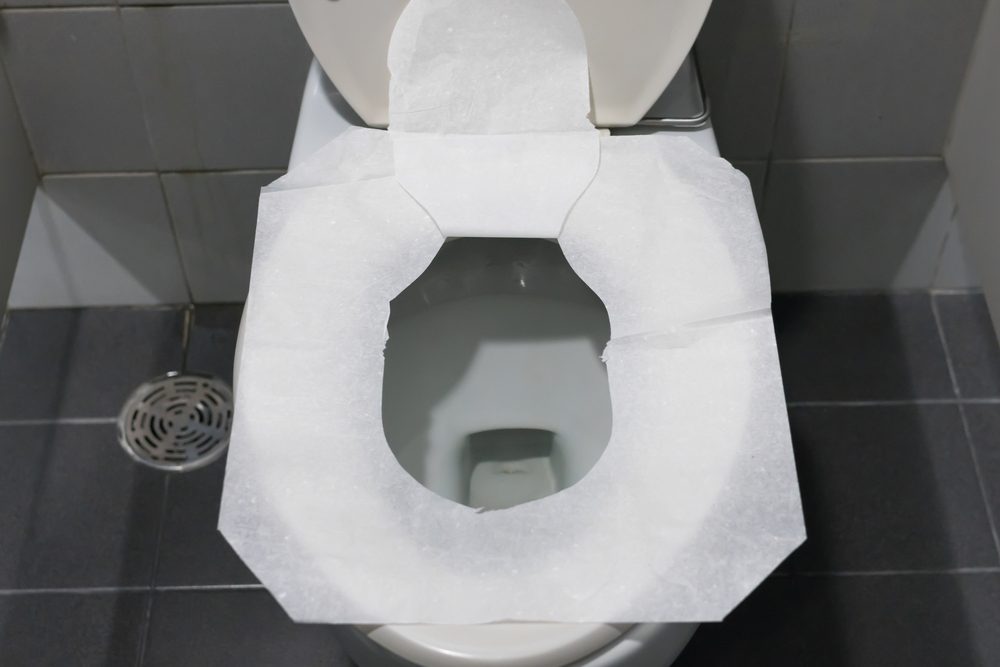 Toilet paper put on Open Toilet seat. Cover The Toilet Seat With Tissue Paper.