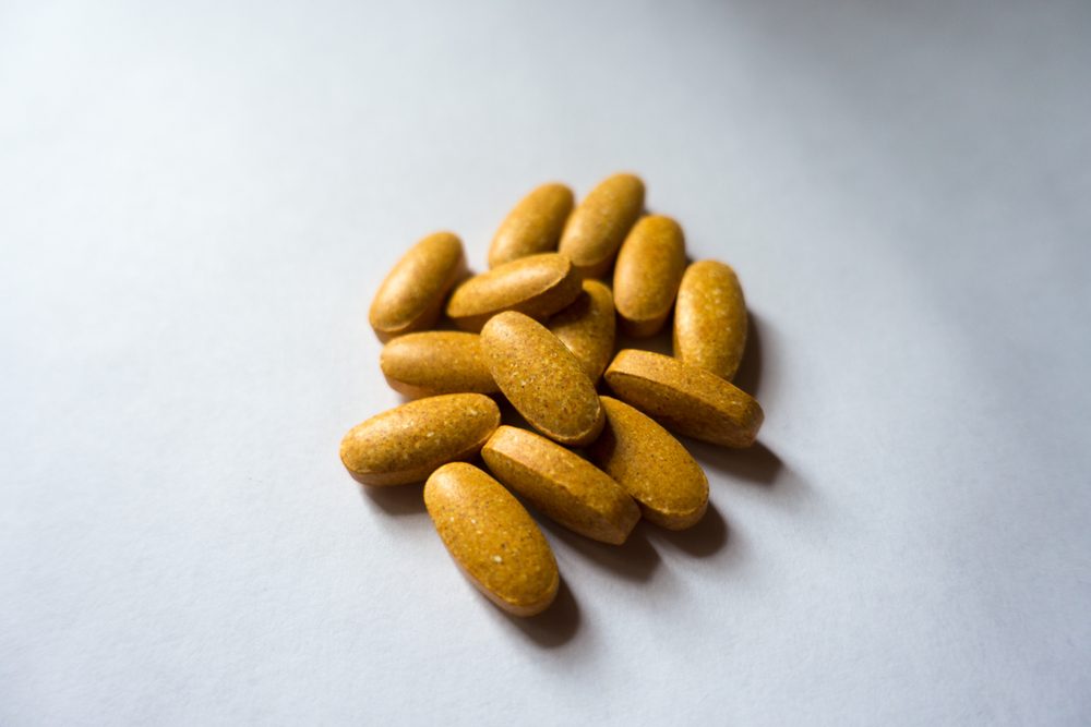 Big oblong orange tablets of multivitamin complex